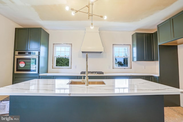 kitchen with green cabinetry, light stone countertops, oven, and custom range hood