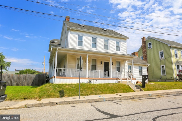 front facade with a front lawn and a porch