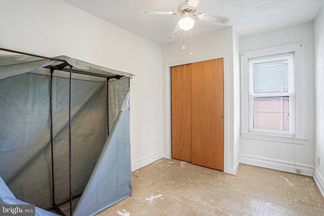 unfurnished bedroom featuring ceiling fan