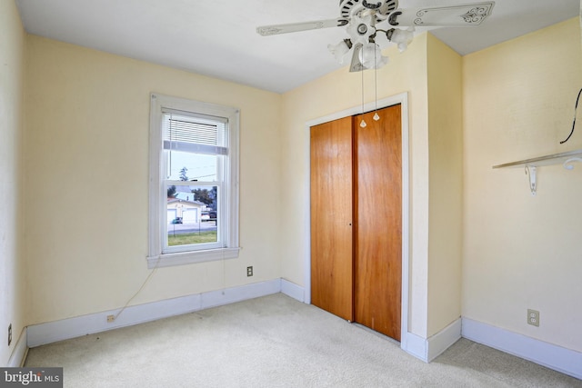 unfurnished bedroom with carpet floors, ceiling fan, and a closet