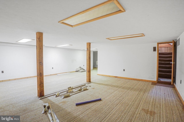 basement featuring light colored carpet