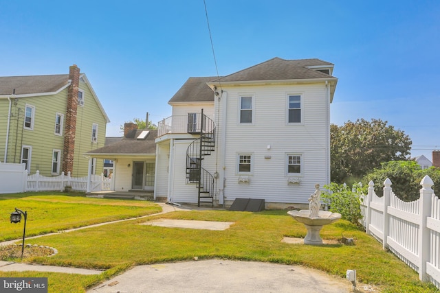 rear view of property featuring a yard