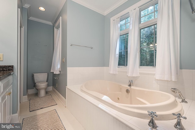 bathroom with tile patterned flooring, tiled tub, ornamental molding, vanity, and toilet