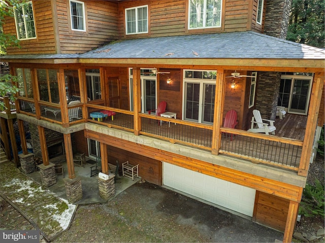 exterior space with a garage and a deck