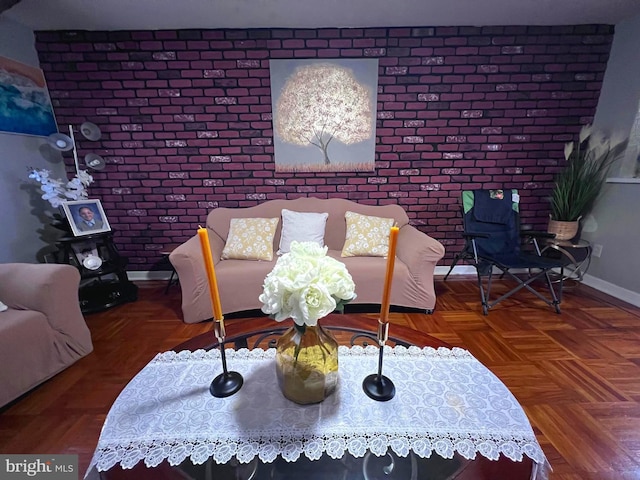 living room with brick wall and parquet floors