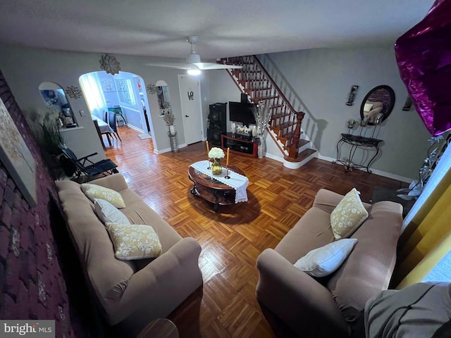 living room with parquet floors and ceiling fan