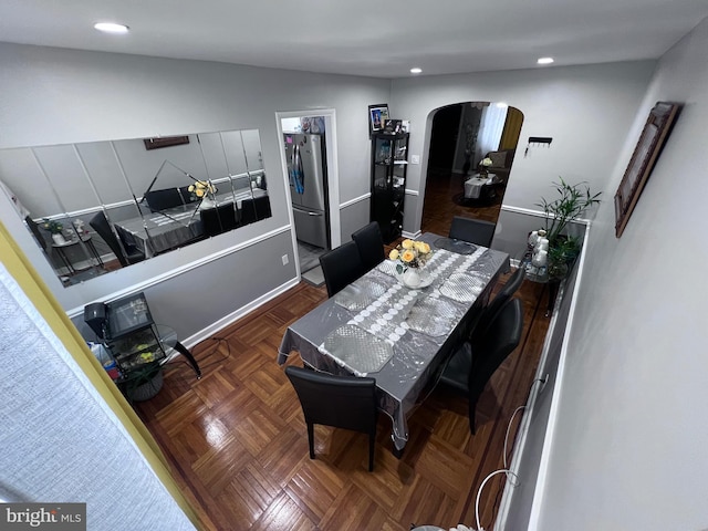 dining room featuring dark parquet floors