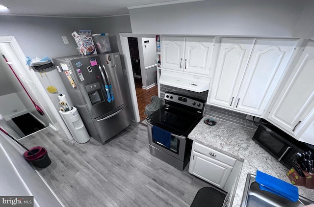 kitchen with light wood-type flooring, white cabinetry, stainless steel appliances, and range hood