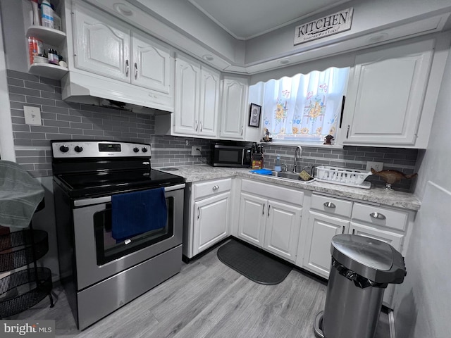 kitchen featuring backsplash, light hardwood / wood-style floors, white cabinetry, sink, and stainless steel range with electric cooktop