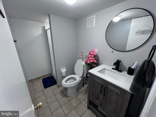 bathroom with tile patterned floors, toilet, a shower with door, and vanity