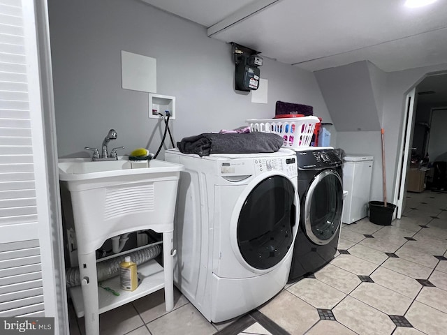 washroom featuring light tile patterned flooring and separate washer and dryer