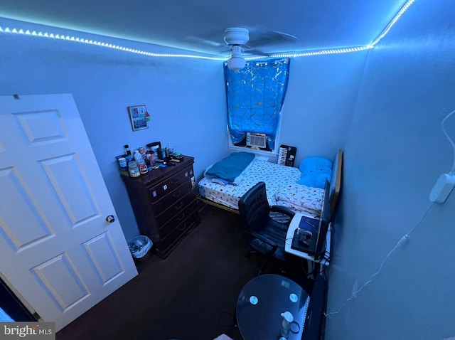 bedroom featuring cooling unit and ceiling fan