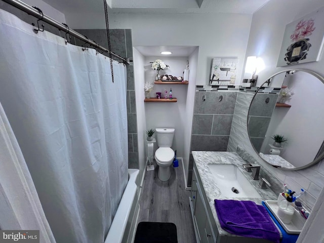 bathroom featuring toilet, hardwood / wood-style flooring, and vanity