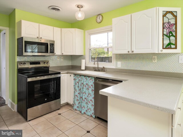 kitchen featuring appliances with stainless steel finishes, sink, and white cabinets