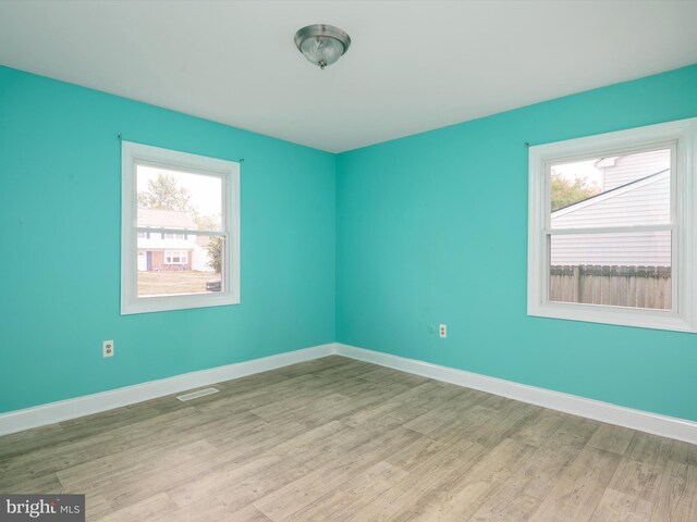 spare room featuring light hardwood / wood-style floors