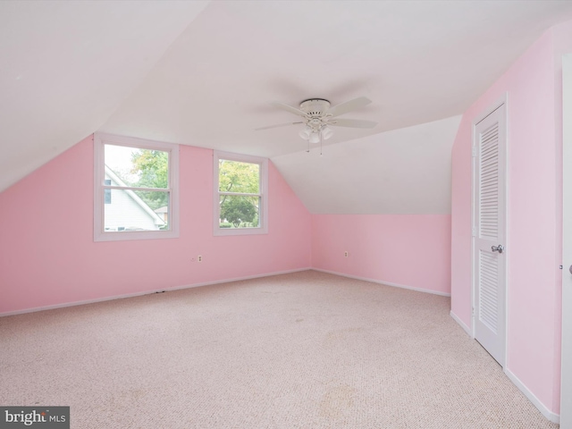 bonus room featuring lofted ceiling, light colored carpet, and ceiling fan