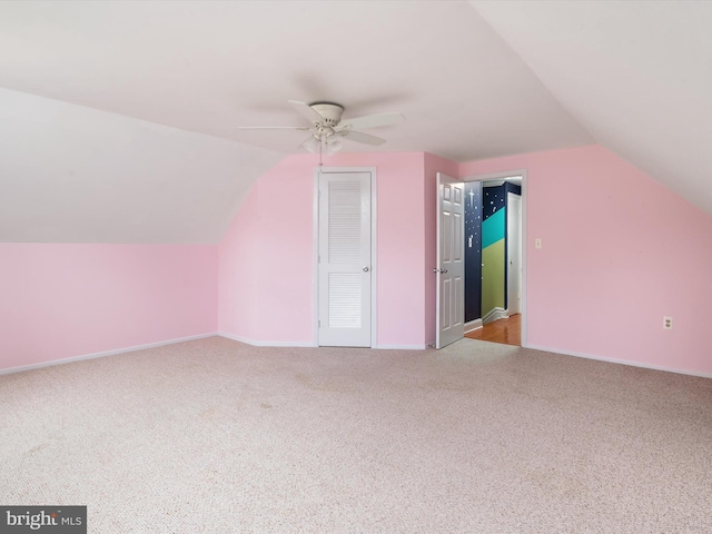 bonus room with vaulted ceiling, light colored carpet, and ceiling fan