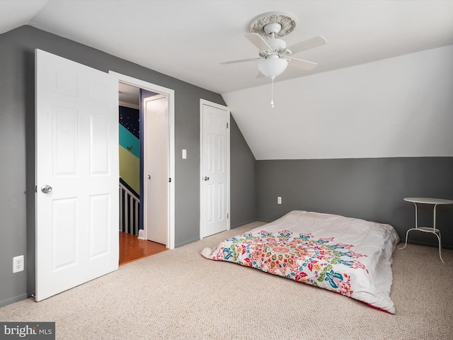 bedroom featuring lofted ceiling, carpet flooring, and ceiling fan