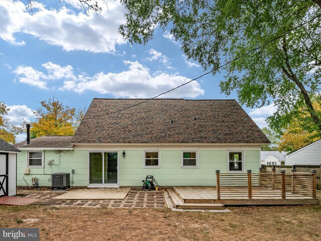 rear view of house with cooling unit, a patio, and a deck