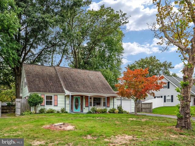 view of front of house with a garage and a front lawn