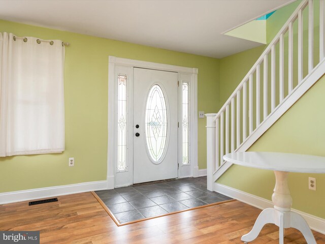 foyer entrance featuring dark wood-type flooring