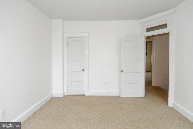 interior space with a closet and light colored carpet