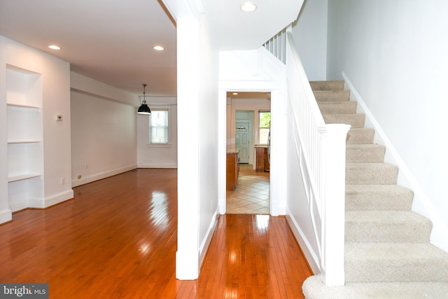 staircase with hardwood / wood-style flooring