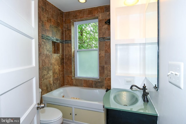 full bathroom with tiled shower / bath, vanity, and toilet