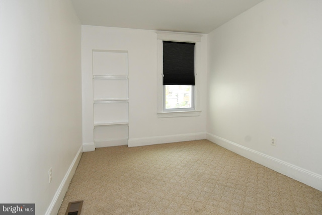 empty room with light colored carpet