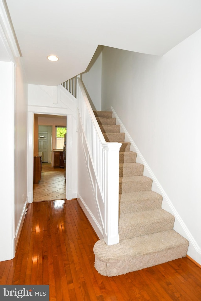 staircase featuring hardwood / wood-style flooring