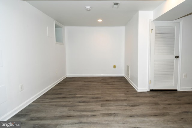 unfurnished room with dark hardwood / wood-style flooring