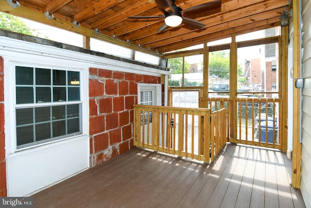 unfurnished sunroom featuring ceiling fan and lofted ceiling with beams