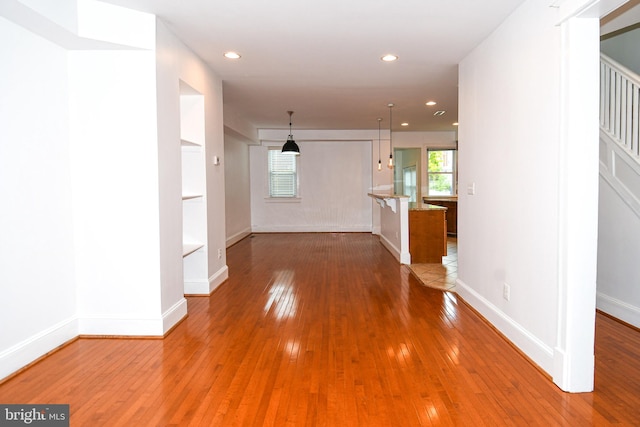 unfurnished living room with hardwood / wood-style flooring