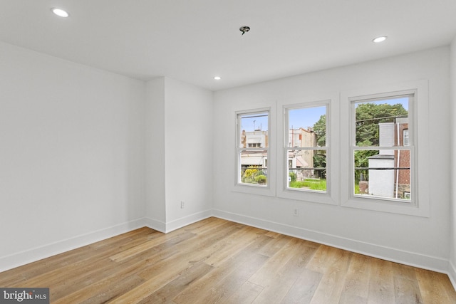 spare room featuring light hardwood / wood-style flooring