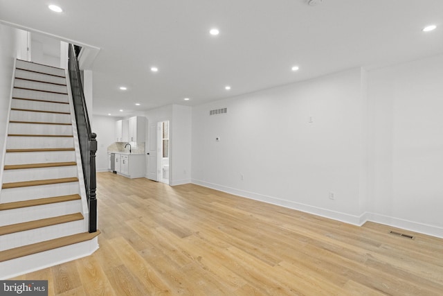 unfurnished living room featuring light hardwood / wood-style floors