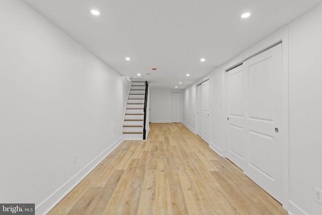 basement with light hardwood / wood-style floors