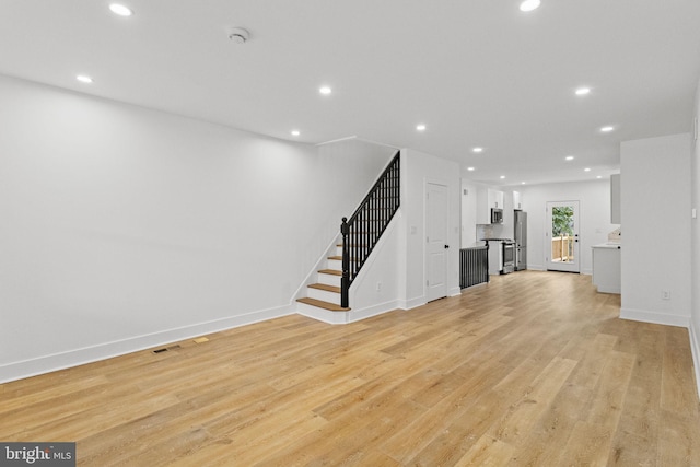 unfurnished living room featuring light wood-type flooring