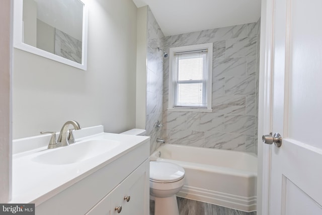 bathroom featuring vanity,  shower combination, toilet, and wood finished floors
