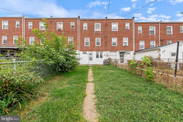 exterior space with cooling unit and a fenced backyard