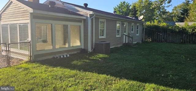 view of property exterior with central AC and a yard