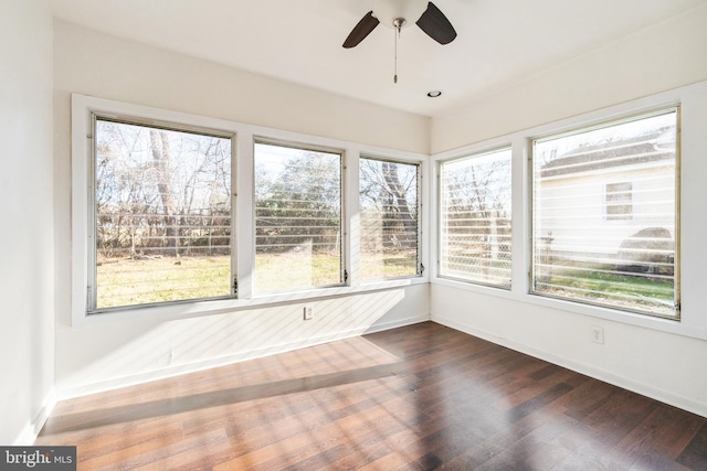 unfurnished sunroom with ceiling fan