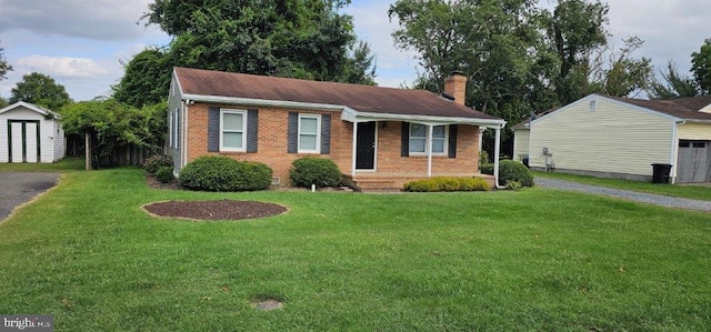 view of front of home featuring a shed and a front lawn