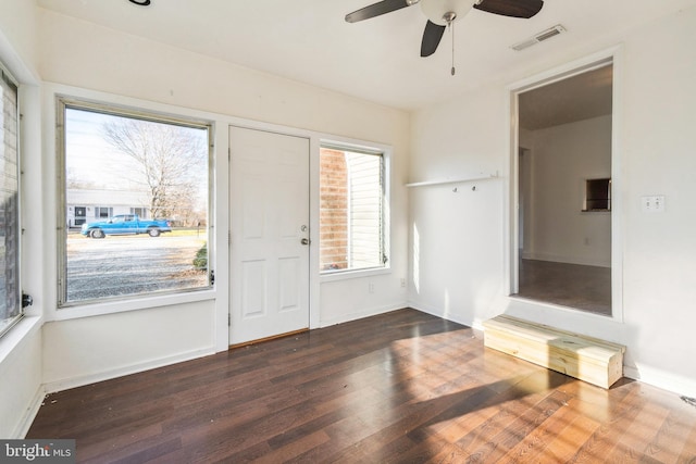 foyer with dark hardwood / wood-style floors and ceiling fan