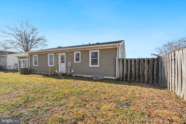 view of front facade with a front lawn and central AC unit