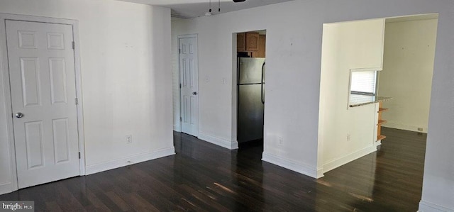 unfurnished room featuring ceiling fan and dark hardwood / wood-style floors