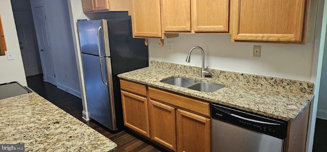 kitchen featuring light stone countertops, appliances with stainless steel finishes, and sink