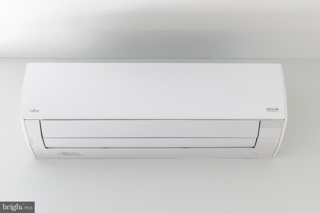 details featuring a wall mounted air conditioner