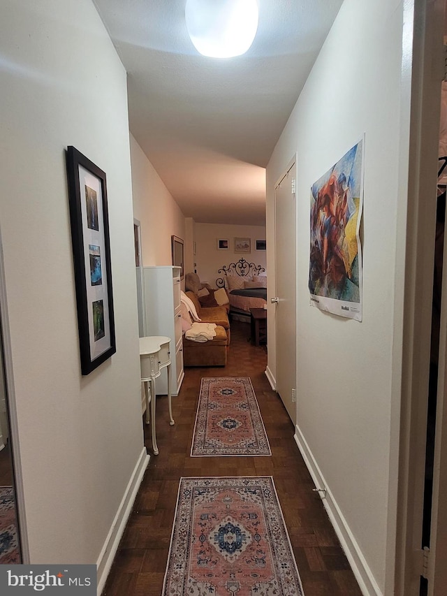 hallway with dark hardwood / wood-style flooring