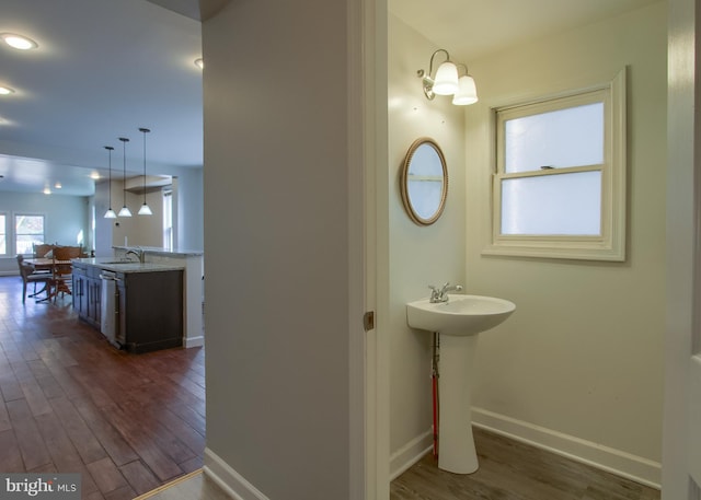 bathroom featuring sink, a chandelier, and wood-type flooring