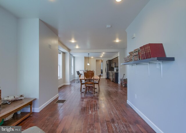 dining area featuring dark wood-type flooring